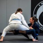 two ladies training jiu jitsu